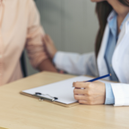 How Does Emergency Contraception Work? Woman talking with doctor about "How Emergency Contraception Works"