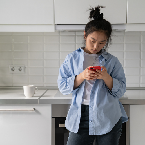 Can Emergency Contraception Cause Abortion? Woman searching on her phone "Can Emergency Contraception Cause Abortion?"
